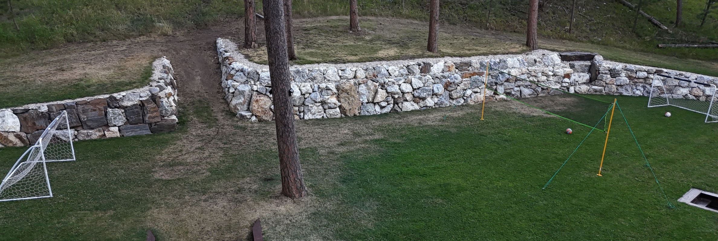 A stone wall in the middle of a field.