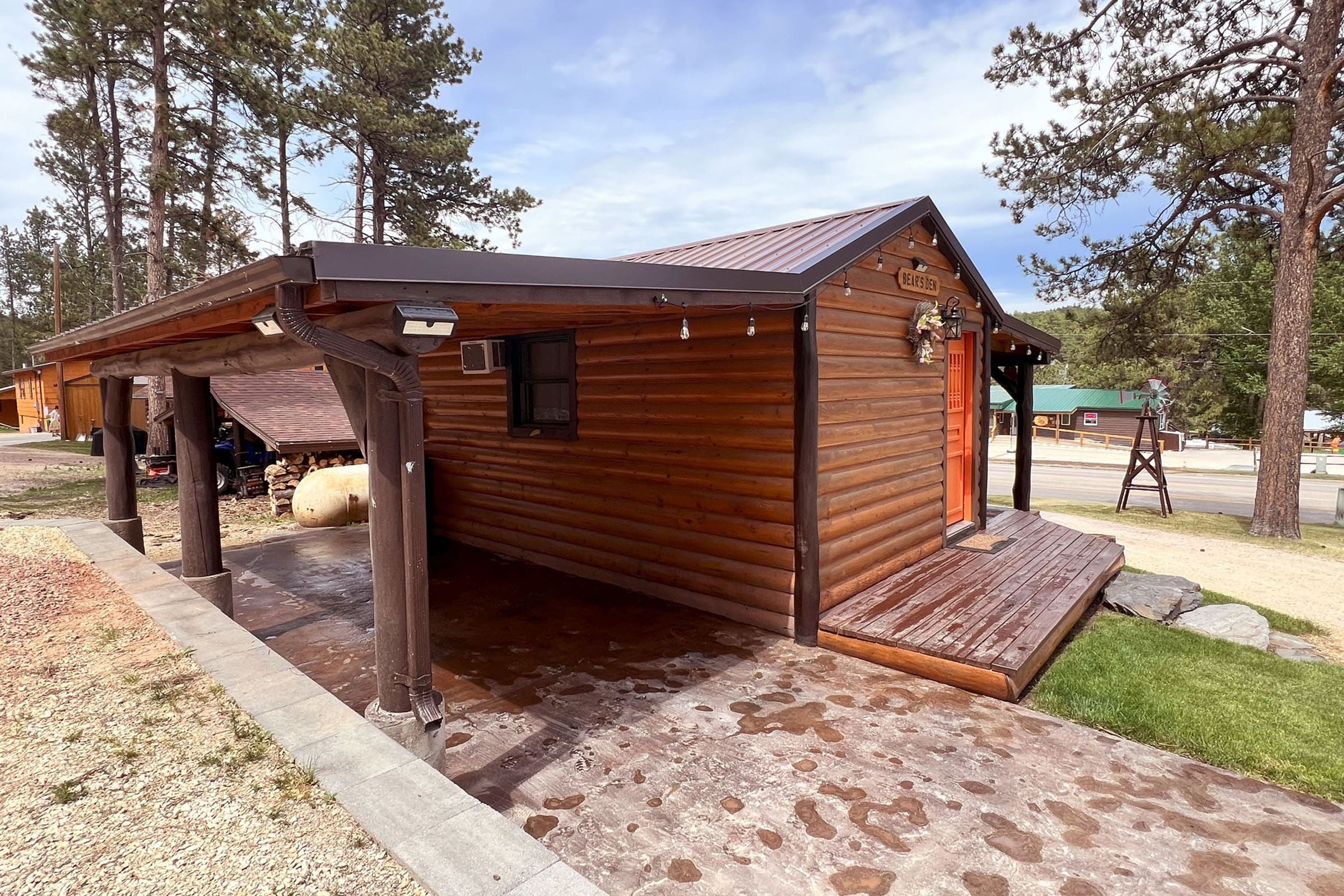 A small cabin with a porch and patio area.