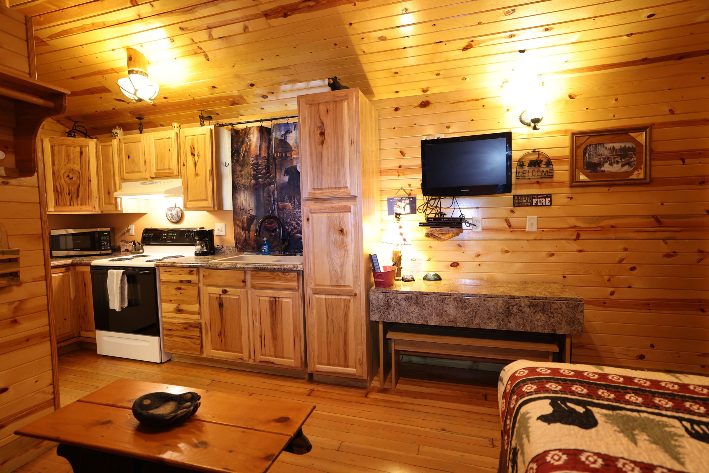 A living room with wood paneling and wooden walls.