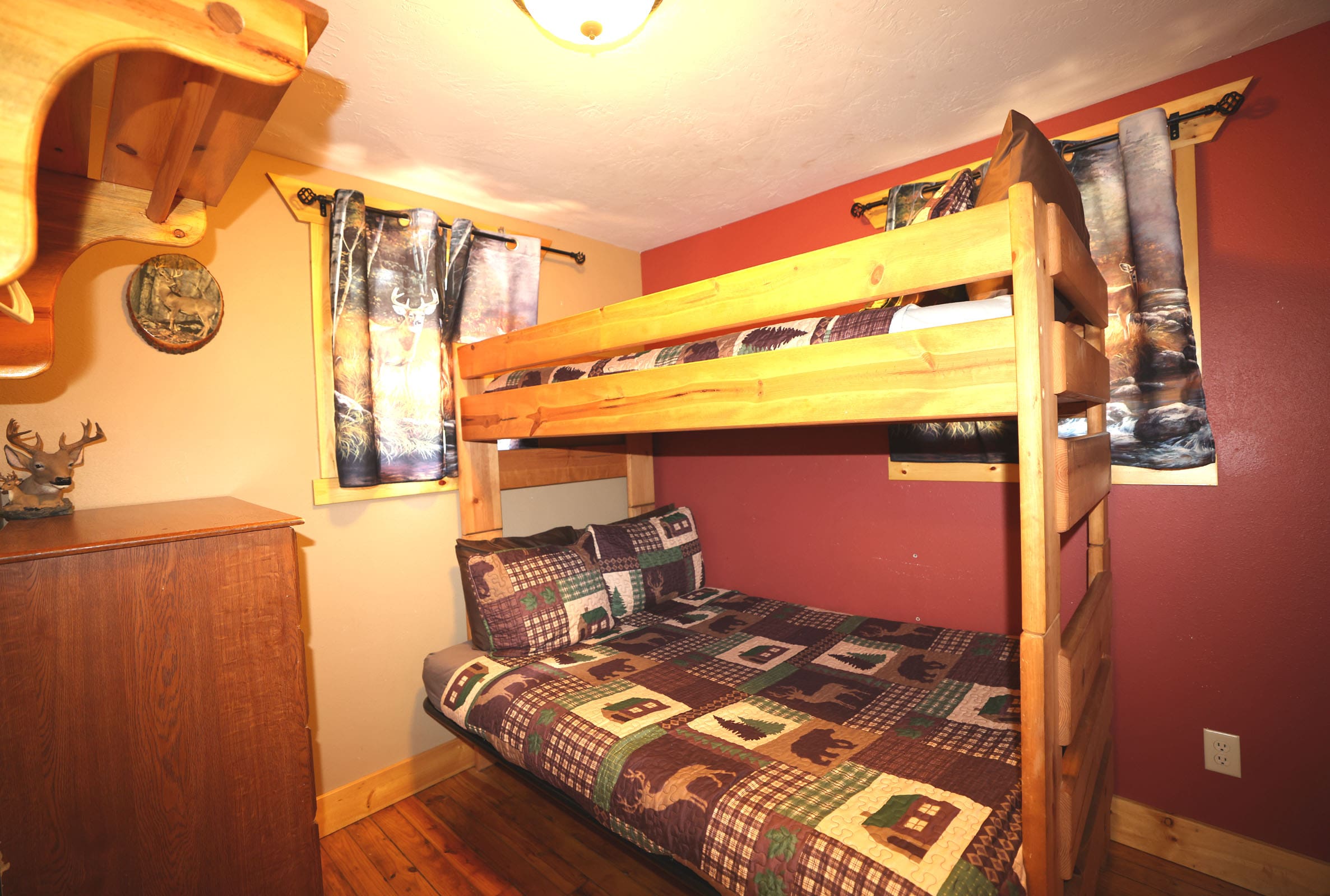 A bedroom with bunk beds and wooden floors.