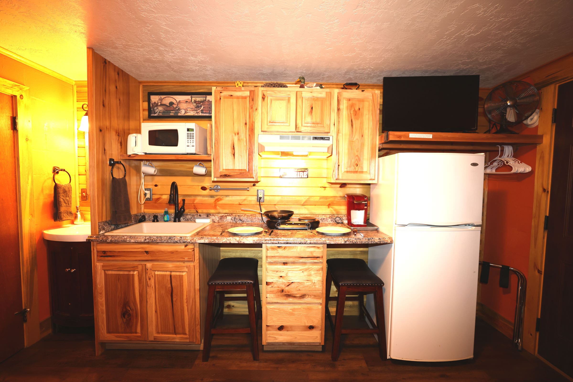 A kitchen with wooden cabinets and white appliances.