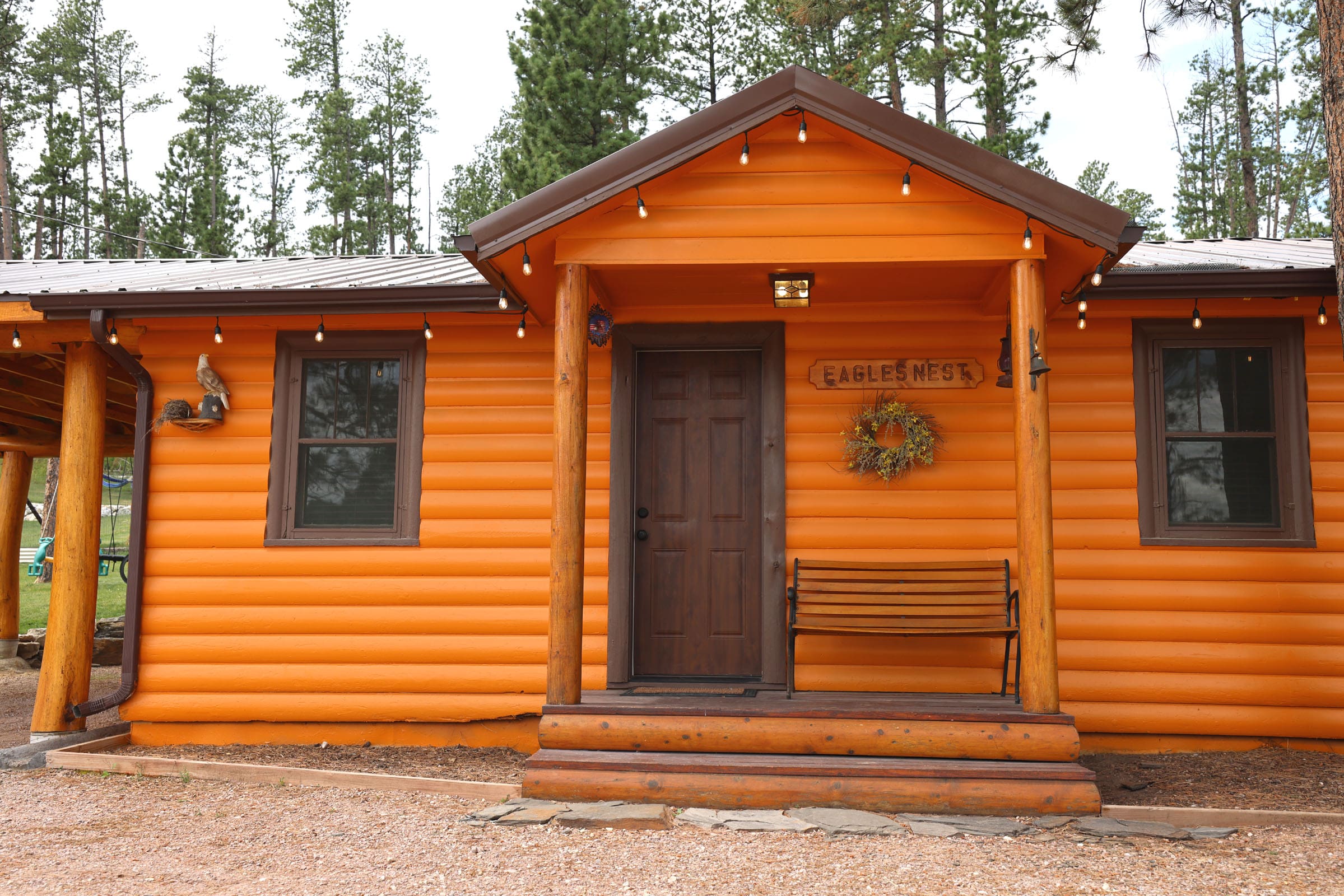 A cabin with a bench and door way.