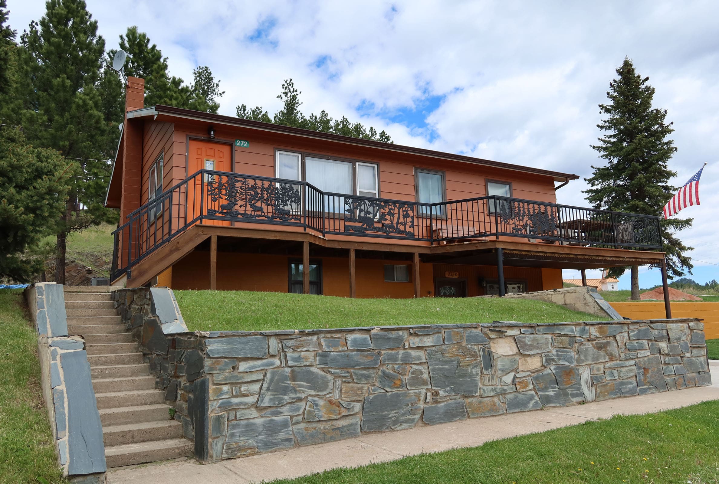 A house with stairs leading up to it's front porch.