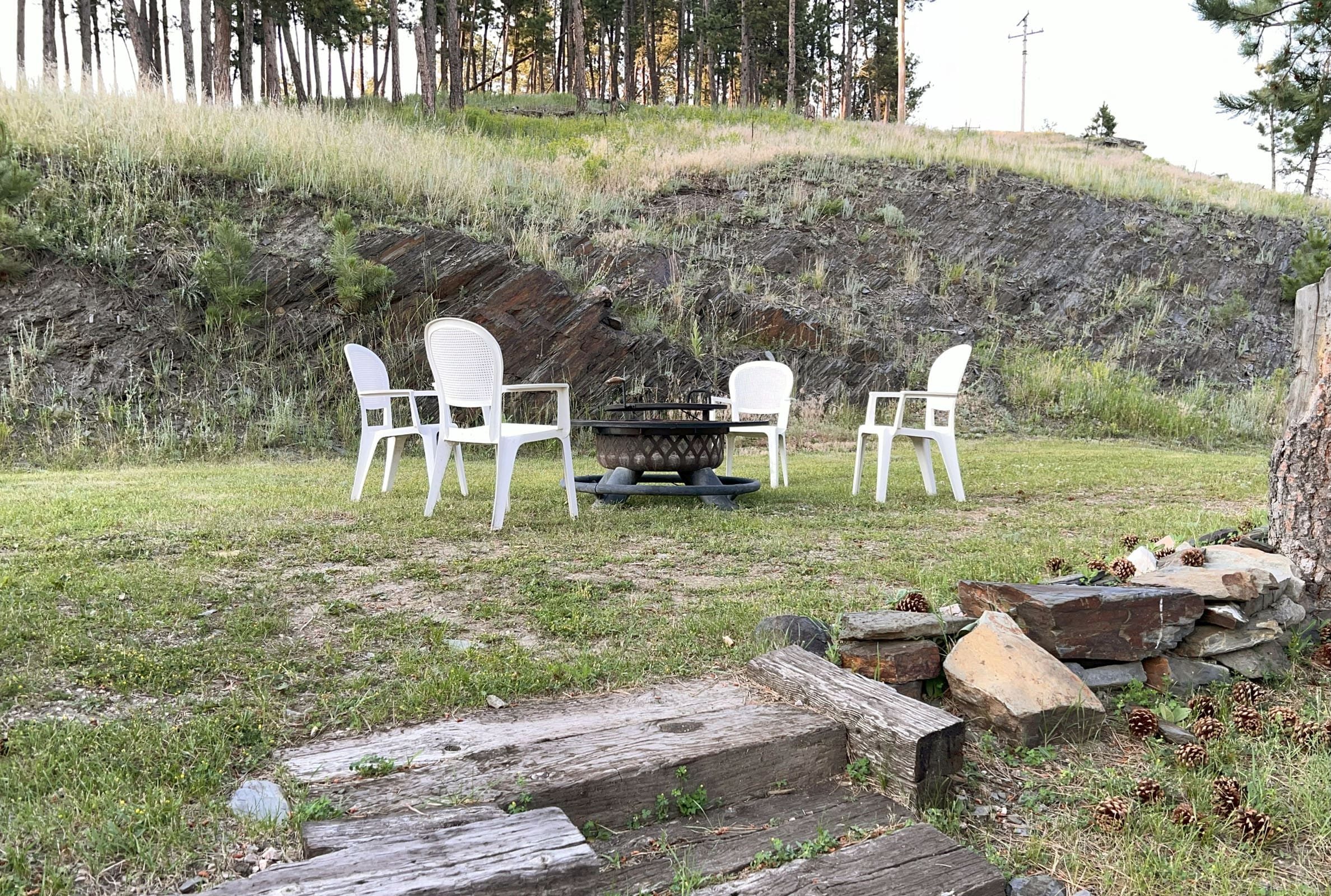 A group of chairs sitting around a fire pit.