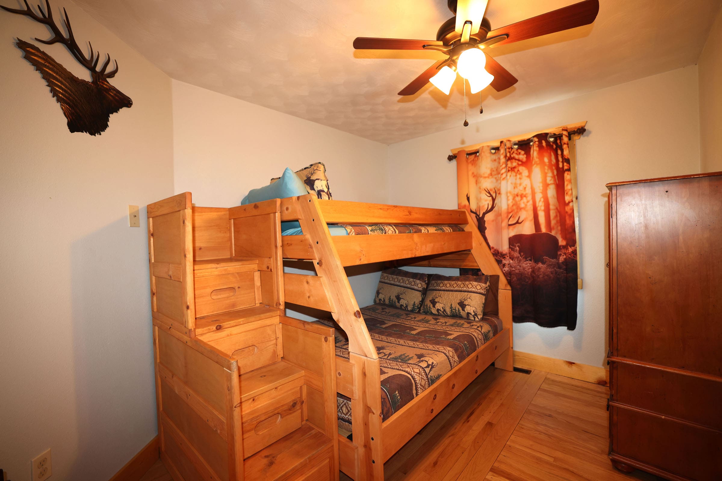 A bedroom with bunk beds and stairs in it