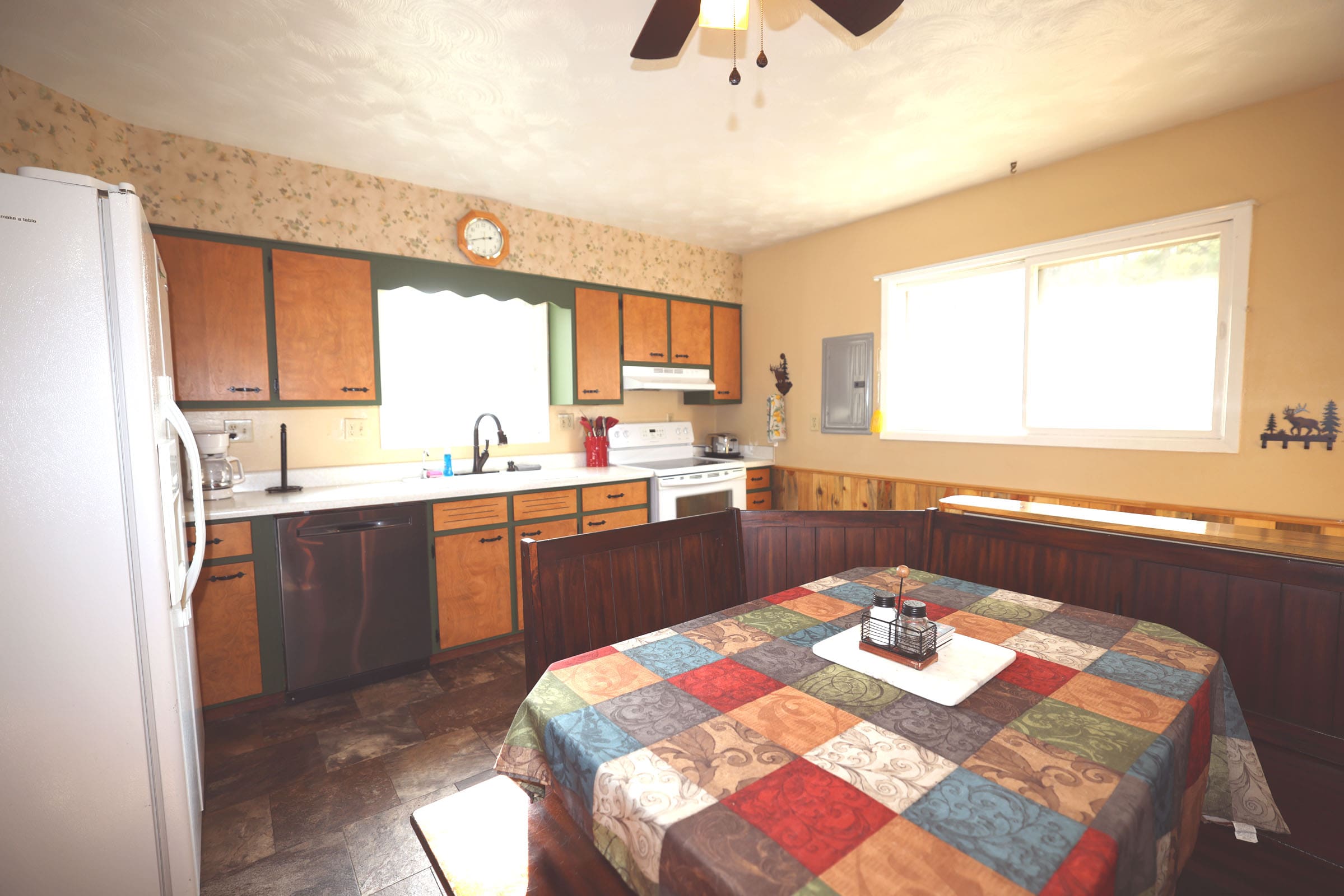 A kitchen with wooden cabinets and brown floor