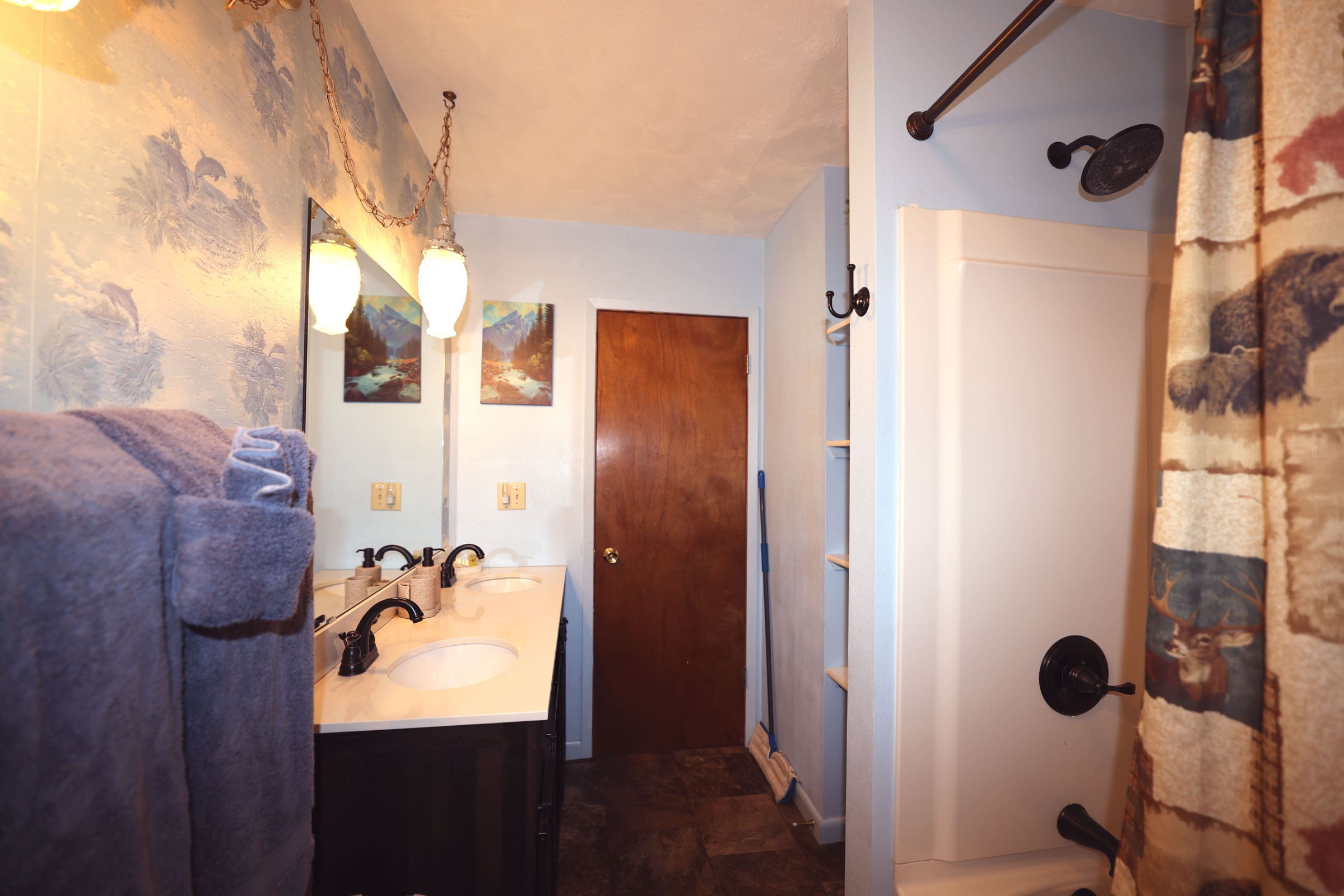 A bathroom with two sinks and a mirror.