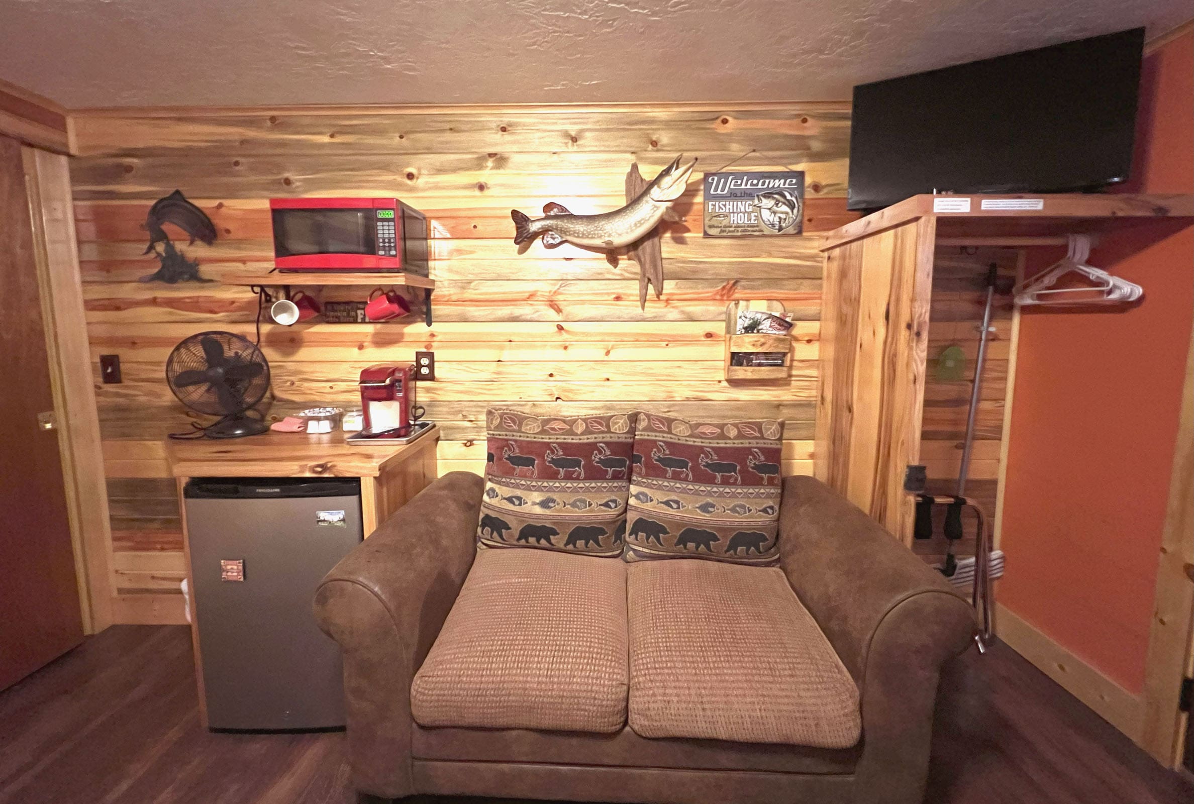 A couch in the living room of a cabin.