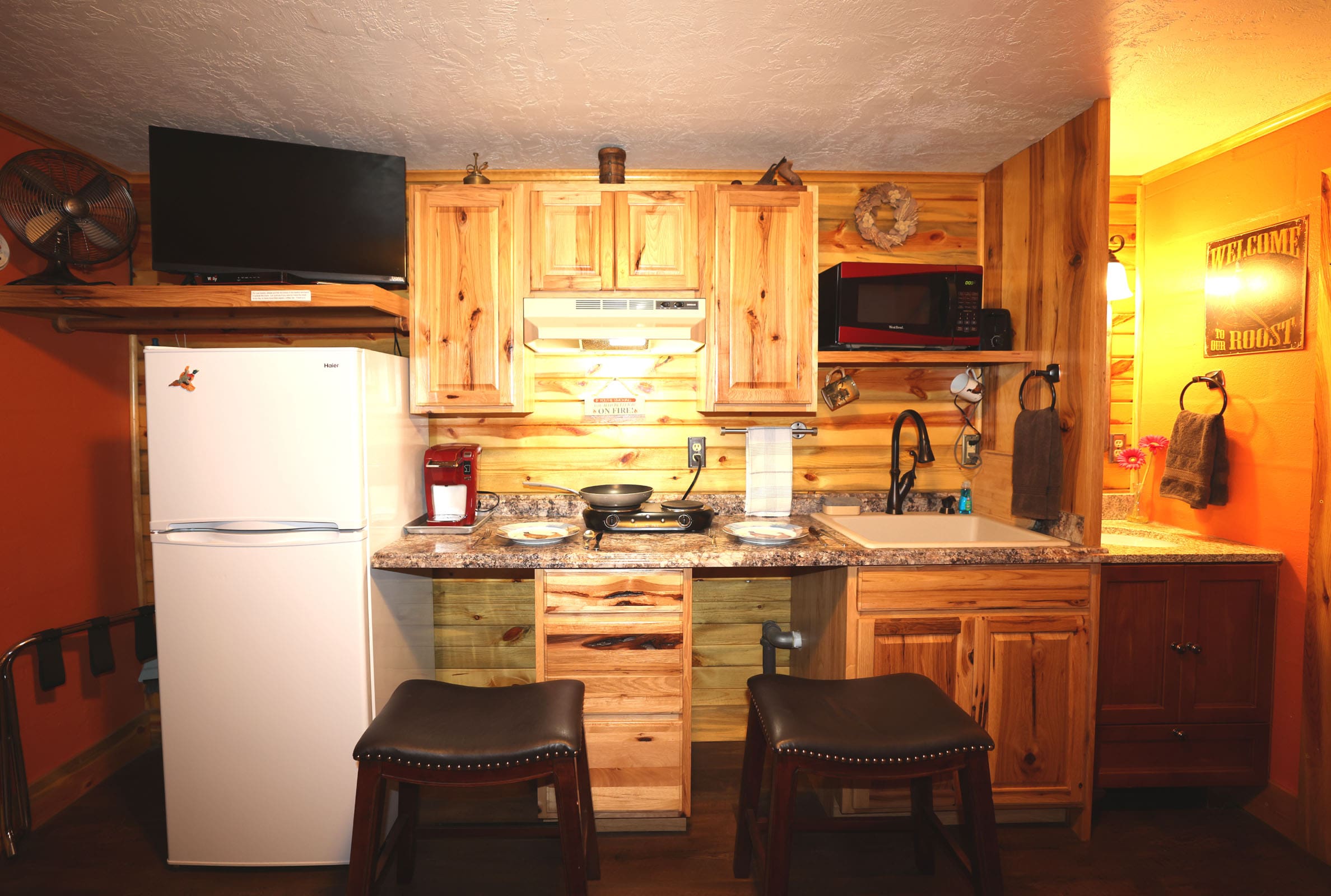 A kitchen with wooden cabinets and a sink.