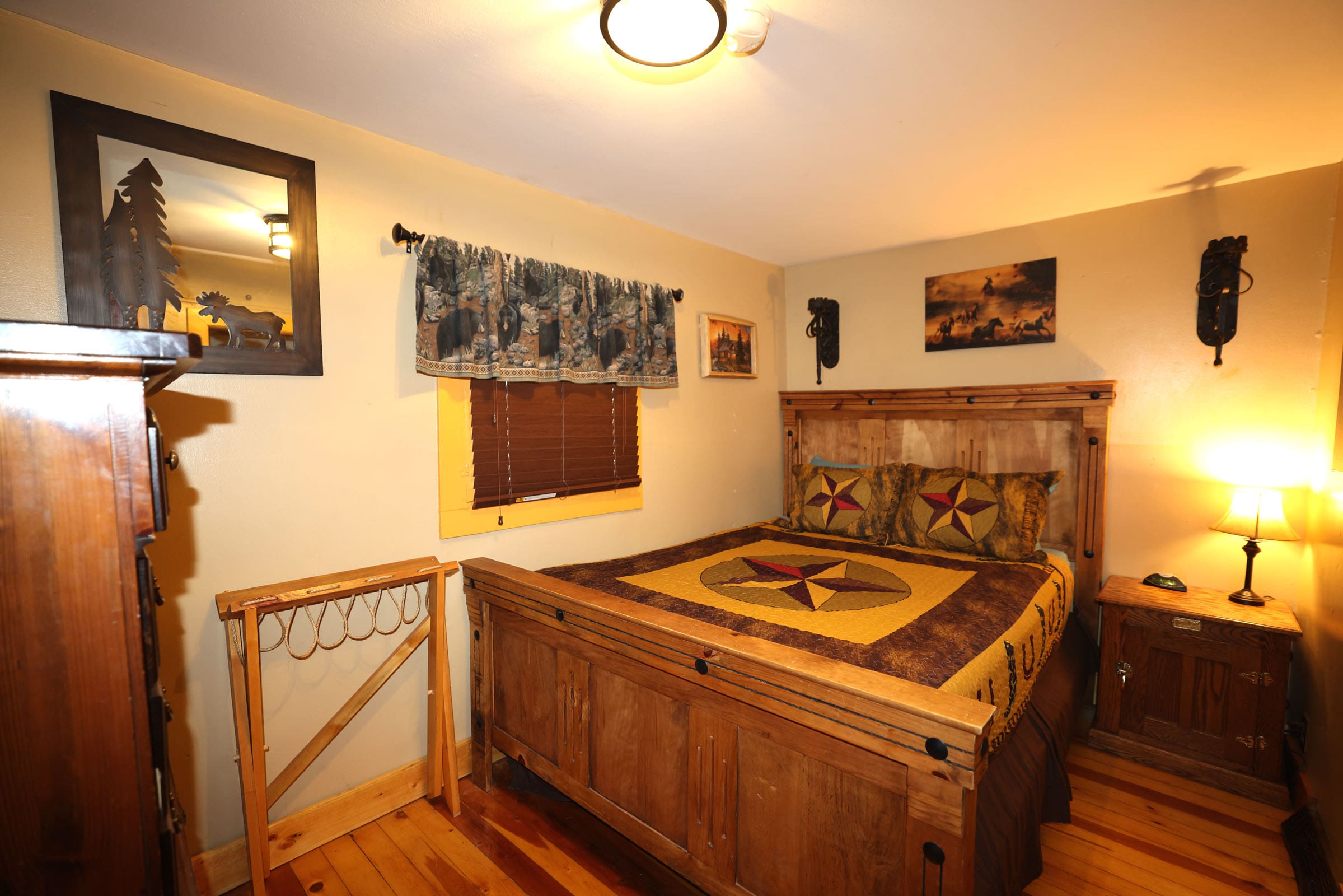 A bedroom with a bed and wooden furniture.