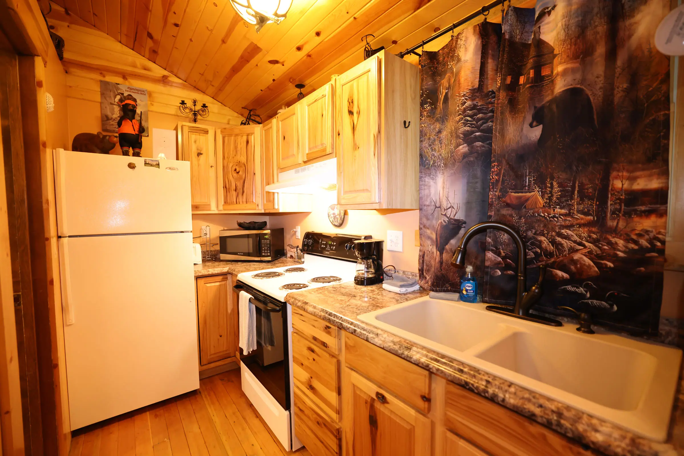 A kitchen with wood cabinets and white appliances.