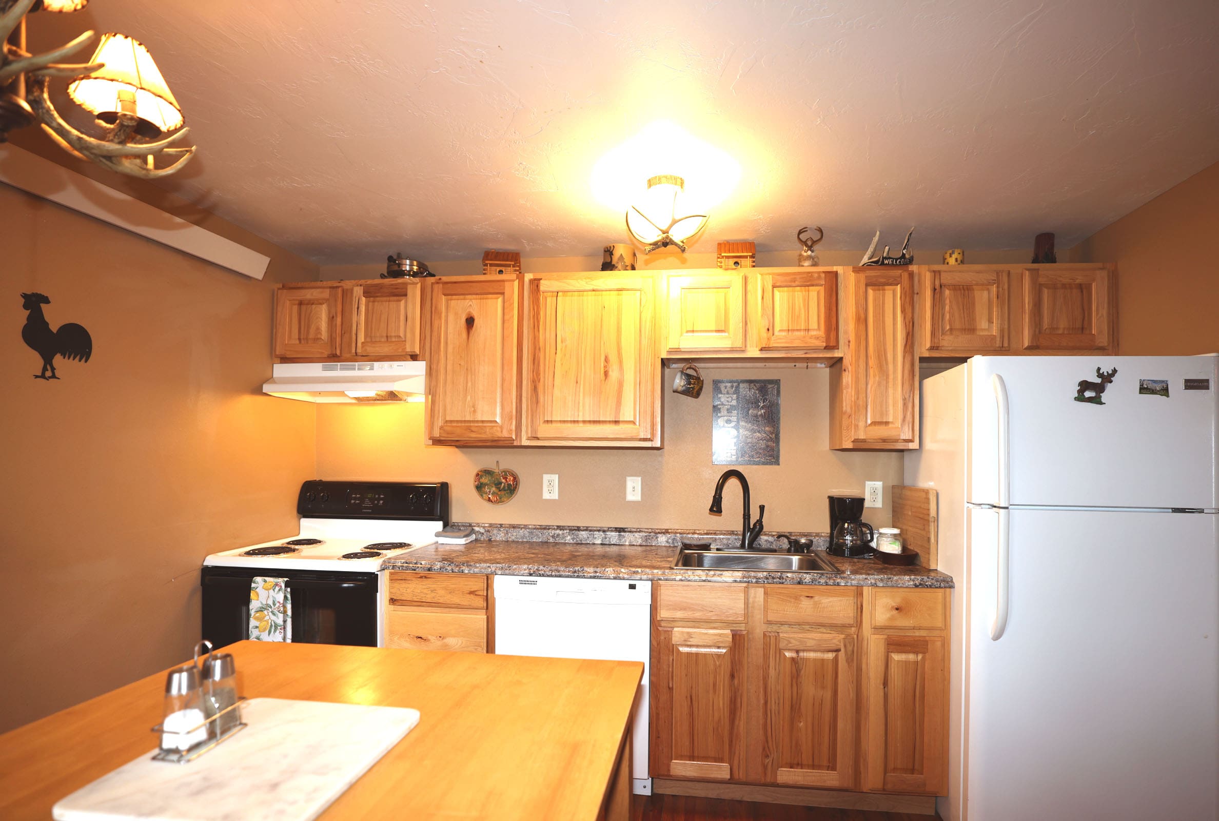 A kitchen with wooden cabinets and white appliances.