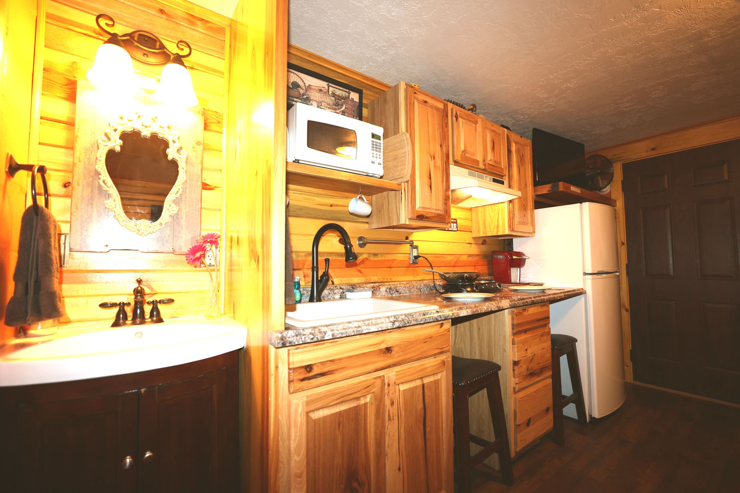 A kitchen with wooden cabinets and a sink.