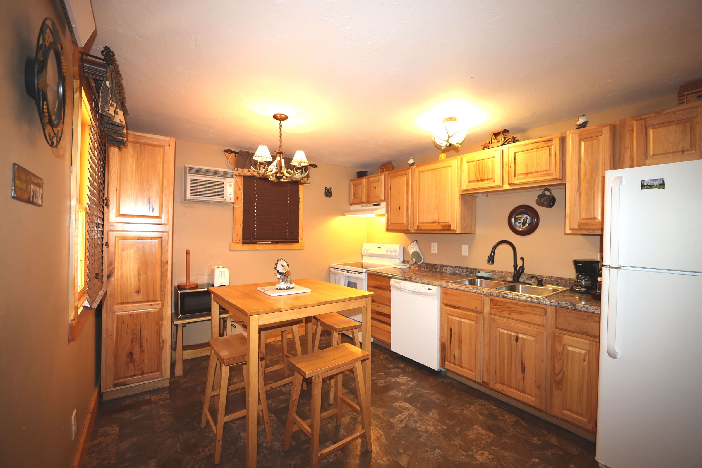 A kitchen with wooden cabinets and a table in it