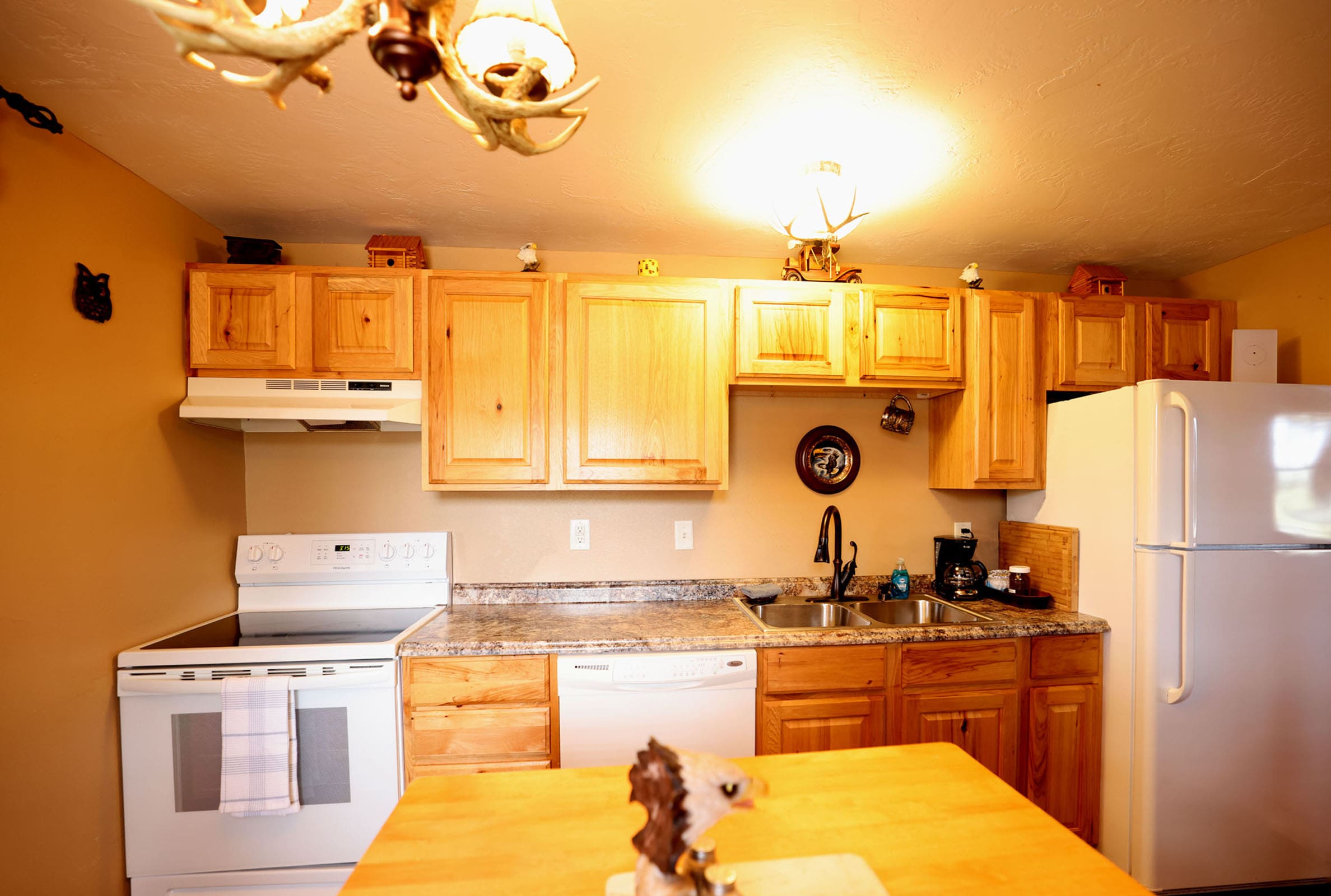 A kitchen with wooden cabinets and white appliances.