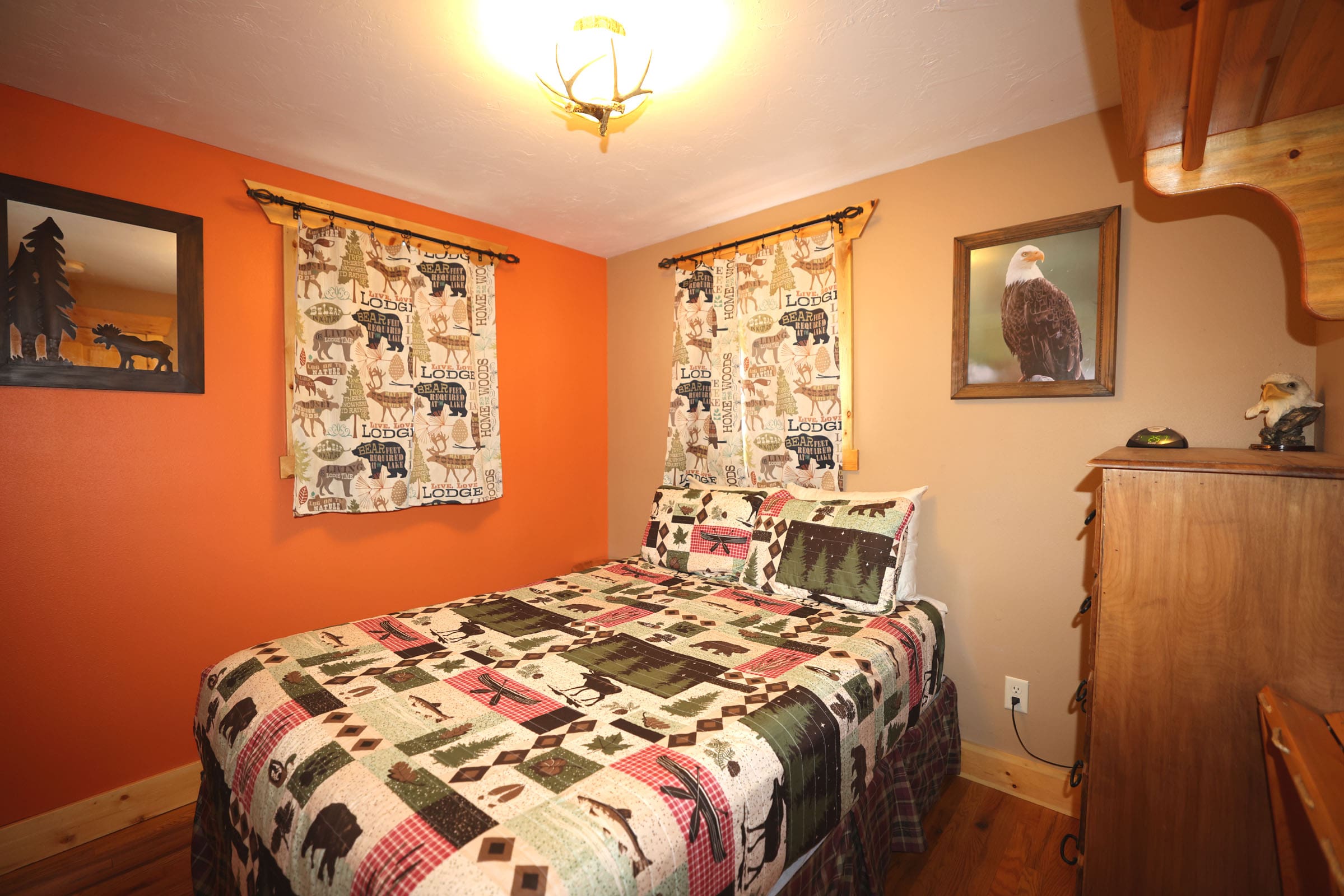 A bedroom with an animal print bedspread and orange walls.