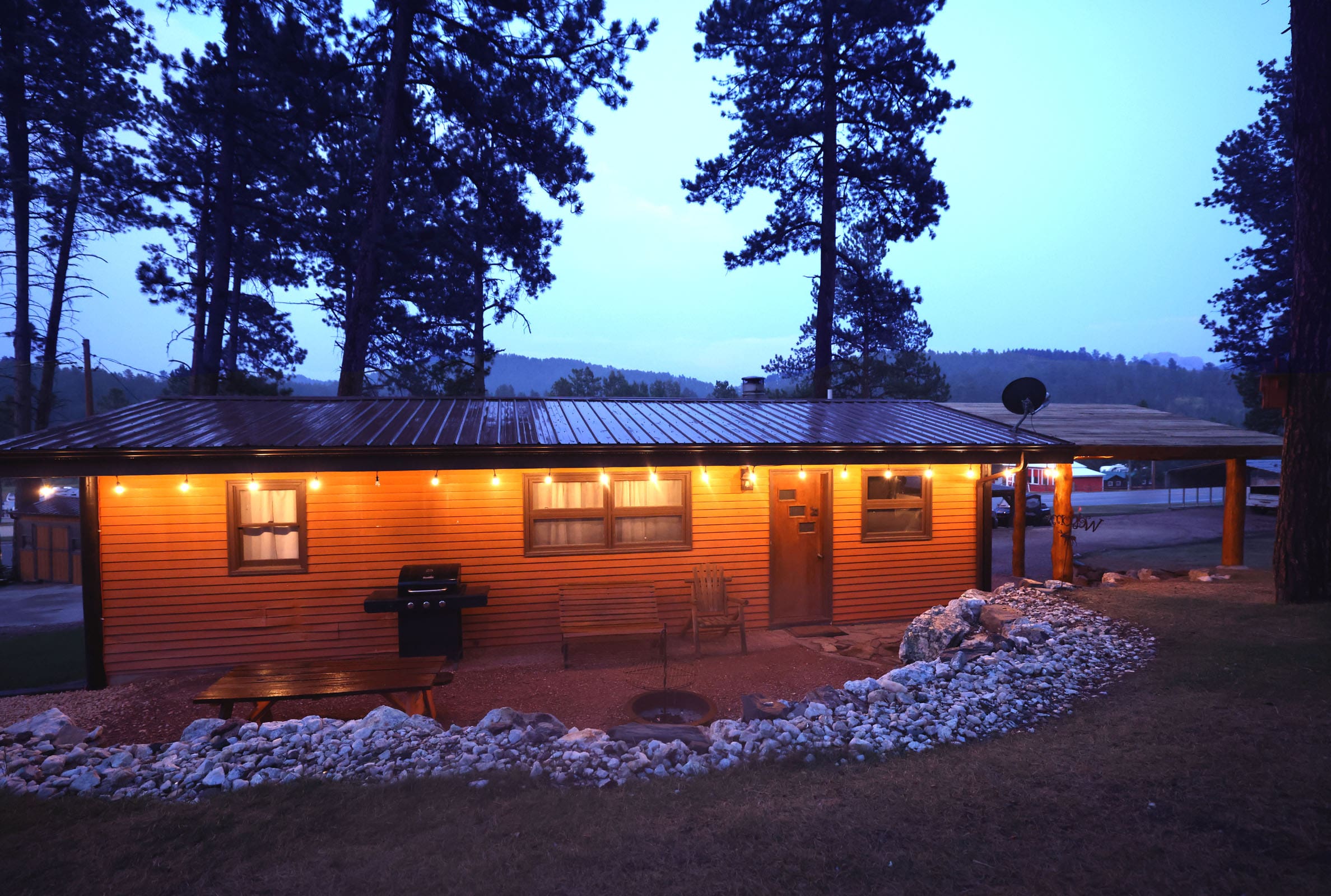 A small house with lights on the outside of it