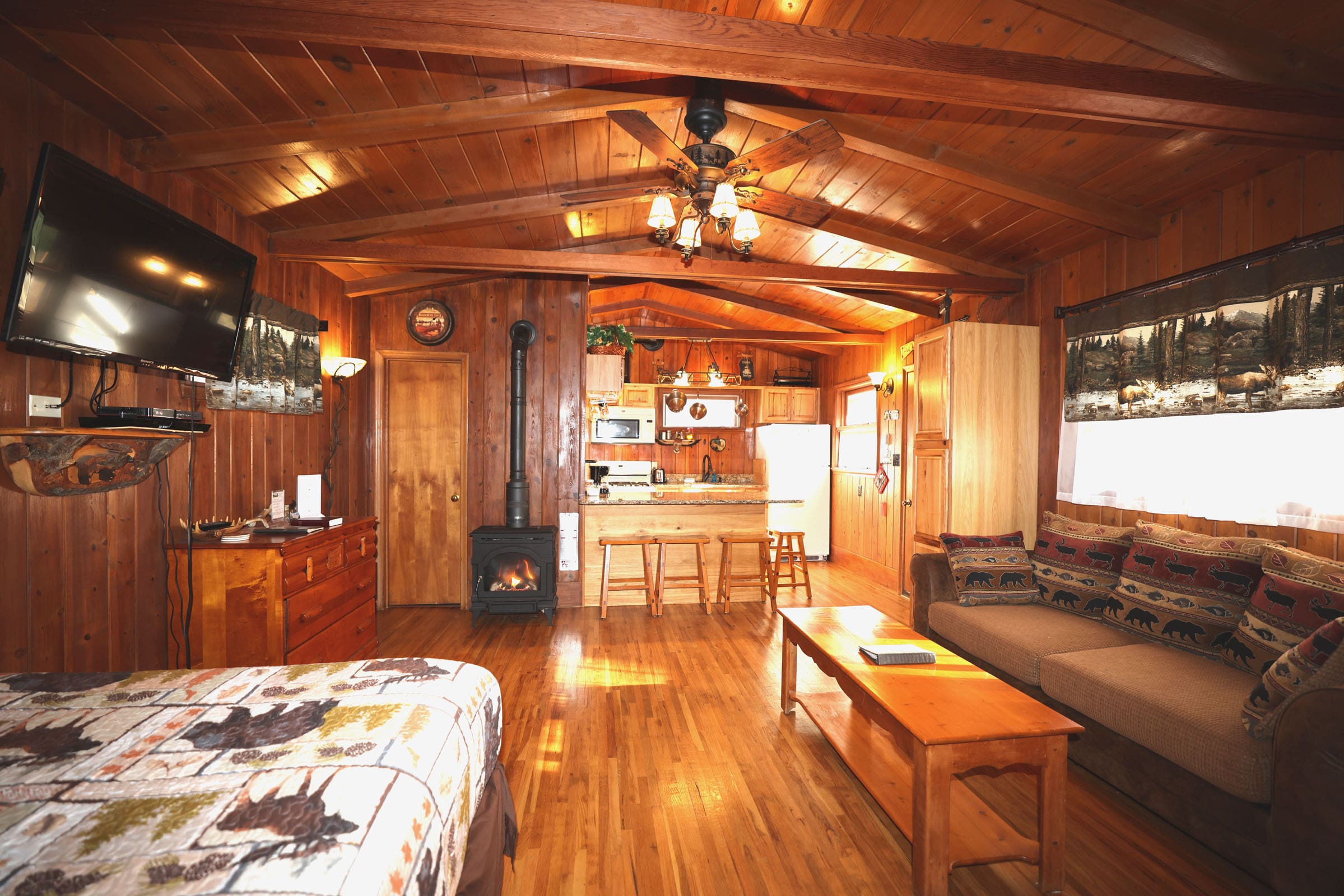 A living room with wood floors and wooden walls.