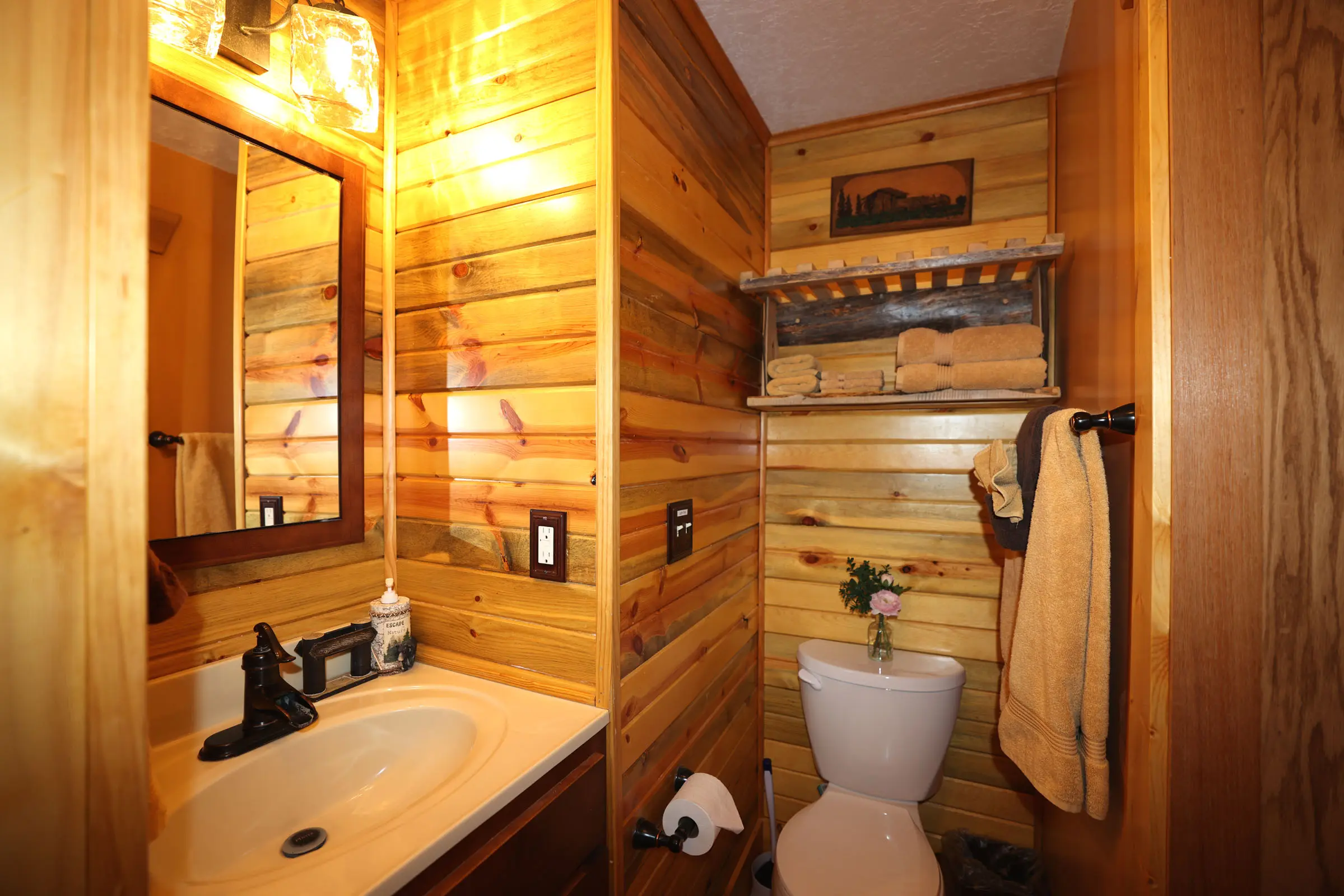 A bathroom with wood paneling and a toilet.